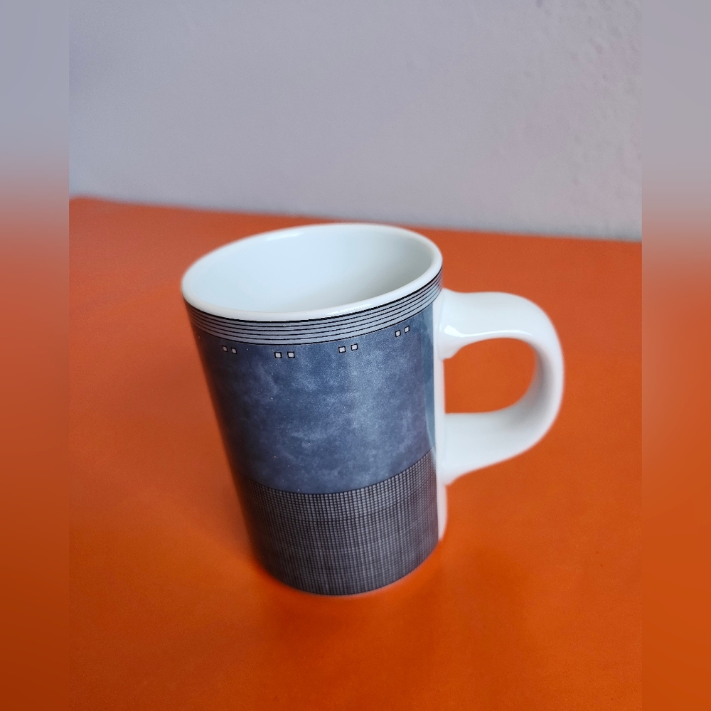 Dansk Gridworks blue and white ceramic mug features a geometric grid pattern.